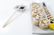 Sushi rolls set on white table