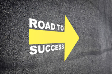 Road to success with yellow arrow marking on road surface.  Transportation concept and business challenge idea