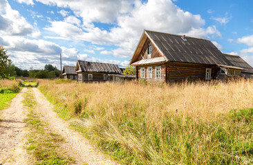 Wall Mural - Old rural wooden houses in abandoned russian village