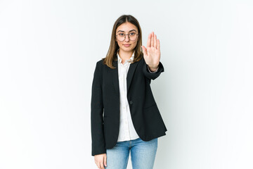 Young caucasian business woman standing with outstretched hand showing stop sign, preventing you.