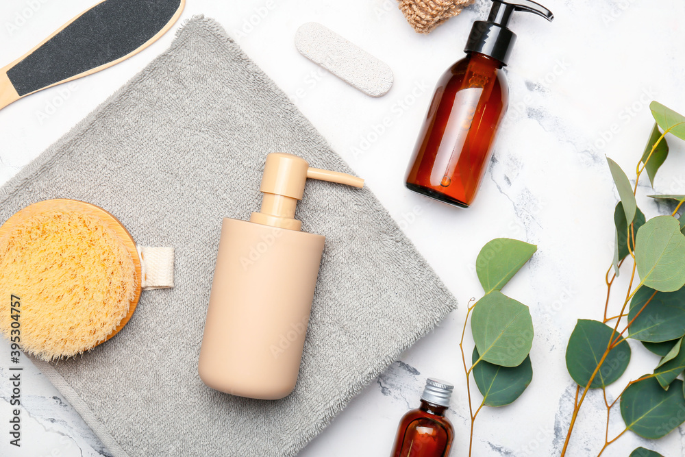 Composition with bath accessories and cosmetics on light background