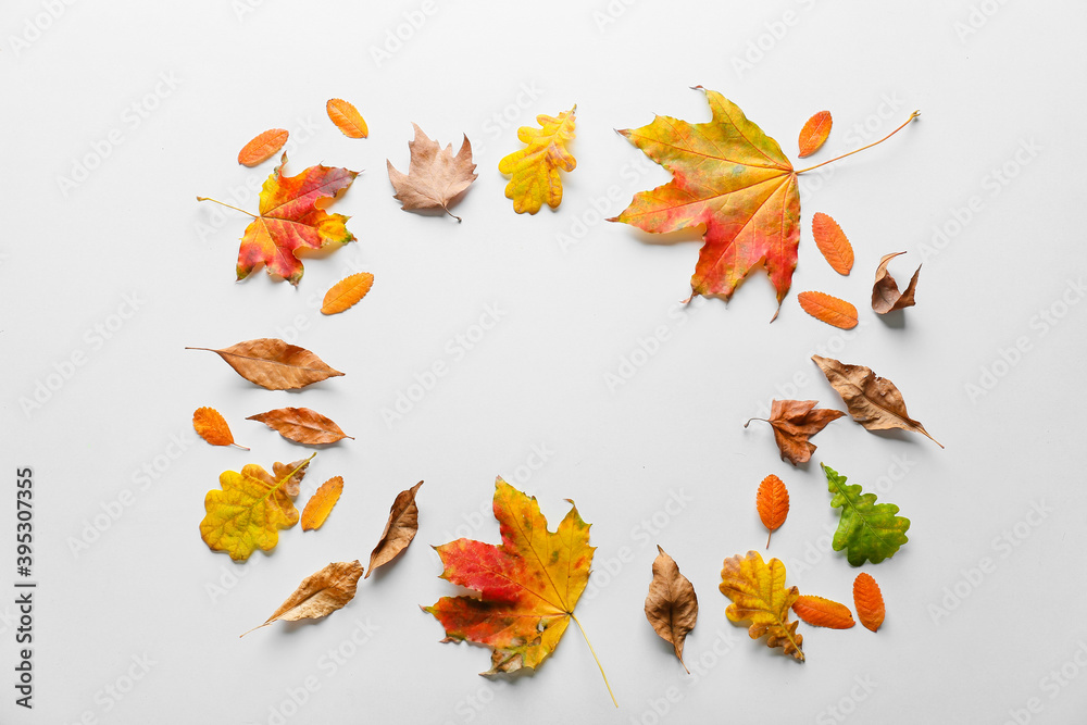 Frame made of autumn leaves on white background