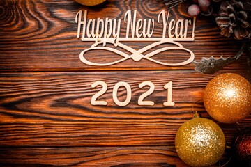 Happy new year 2021 on wooden brown background
