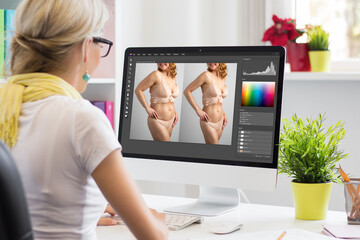 Leinwandbilder - Photo retoucher editing photo on computer and transforming model's body shape in order to make her look slimmer