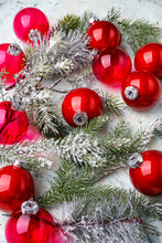 New Year Mockup A Lot Of Red Christmas Tree Toys And With Branches Of A Christmas Tree On A White Background Vertical Photo
