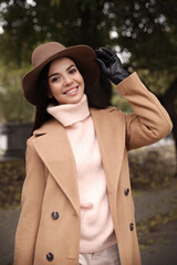 Poster - Young woman wearing stylish clothes in autumn park