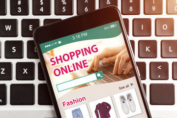 Poster - Mobile Phone With Online Shopping App Lying On Computer Keyboard