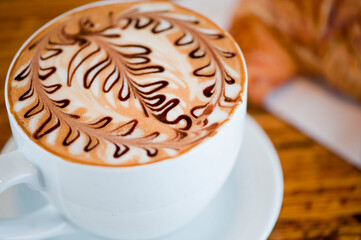 Cappuccino. Fresh cup of dark French roast shot of espresso w/ steamed milk. Classic American. French bistro, coffee house or café beverage. Typical drink served at breakfast. white background