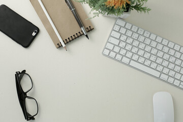 Keyboard mouse glasses pen pencil notepad phone on white background