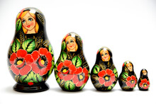 A Set Of Russian Nesting Dolls, Arranged In One Row In Height, And Isolated On A White Background.