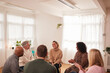 © Monkey Business - Woman Speaking At Support Group Meeting For Mental Health Or Dependency Issues In Community Space