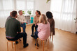 © Monkey Business - Woman Speaking At Support Group Meeting For Mental Health Or Dependency Issues In Community Space