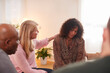 © Monkey Business - Group Consoling Woman Speaking At Support Group Meeting For Mental Health Or Dependency Issues