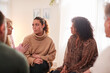 © Monkey Business - Group Consoling Woman Speaking At Support Group Meeting For Mental Health Or Dependency Issues