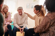 © Monkey Business - Group Consoling Man Speaking At Support Group Meeting For Mental Health Or Dependency Issues