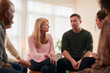 © Monkey Business - Man Speaking At Support Group Meeting For Mental Health Or Dependency Issues In Community Space