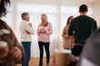 © Monkey Business - Group Of People Drinking Coffee And Chatting At Informal Meeting To Discuss Community Issues