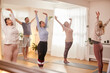 © Monkey Business - Group With Teacher Standing And Stretching In Yoga Class Inside Community Center