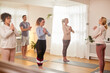 © Monkey Business - Group With Teacher Standing And Meditating In Yoga Class Inside Community Center