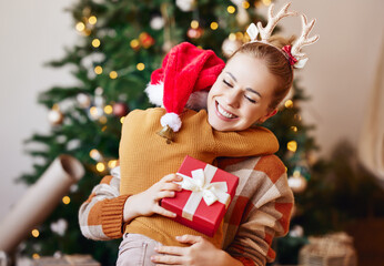 Sticker - Cheerful child congratulating  mother at Christmas