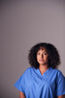 © Monkey Business - Studio Portrait Of Female Nurse Wearing Scrubs Standing Against Grey Background