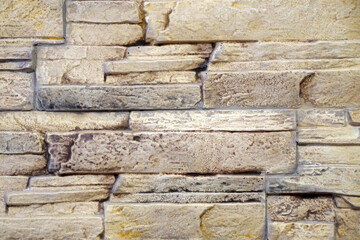 wall trimmed with beige natural stone texture for background