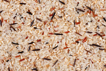 Food background. Brown, white basmati, wild and red rice mix. Flat lay.