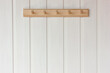 wooden empty hanger on a white wall.