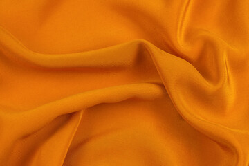 golden silk or satin luxury fabric texture can use as abstract background.