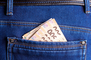 Money in your pocket. Banknotes in the back pocket of denim pants. Rich man. Ukrainian hryvnia.