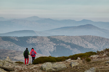 mountaineers walking along the cuerda larga path in the sierra de guadarrama national park. madrid's