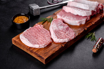 A fresh raw piece of pork escalop cut into several parts