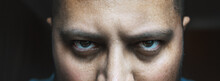 Evil Look Of Angry Or Tired Male With Bags Or Black Circles Under Spooky Eyes, Close Up Portrait. Horror Creepy Demon Or Bad Negative Person Looks At Camera.
