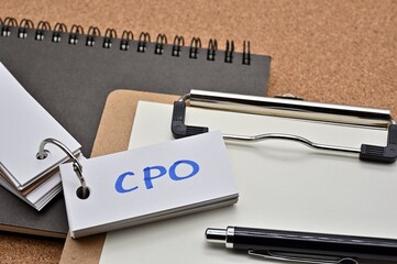 Poster - On top of the notebook and clipboard is a wordbook and pen with the word CPO written on it. It means Cost per Order.
