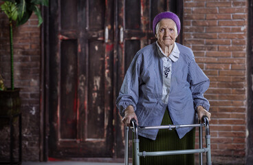 Wall Mural - Portrait of senior woman with walker indoors