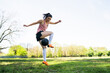 © Mego-studio - Young female soccer player practicing on field.