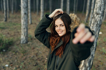 Smiling woman on nature in the woods walk emotions fun