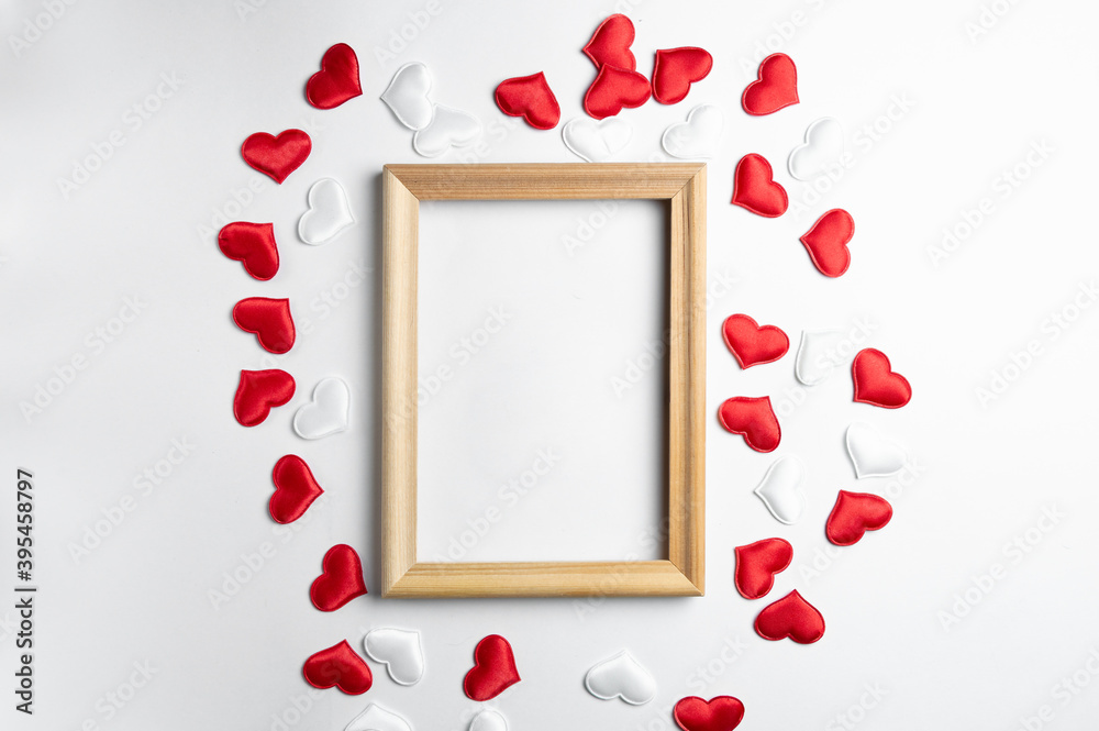 Mockup wooden frame and decorative red and white hearts on a white ...