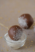 Cakepops With Chocolate Icing And Grated Coconut