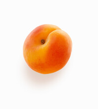 An Apricot On A White Surface