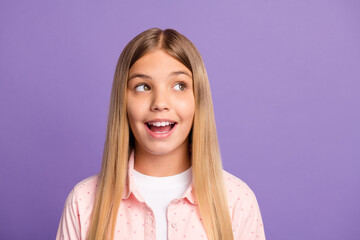 Wall Mural - Portrait of cute optimistic long hairdo pretty girl look empty space wear pink shirt isolated on violet color background