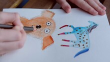 Little Girl Draws A Dog And A Horse On A Sheet Of Paper With Watercolors And Pencils, Children's Creativity And Drawing, Concept