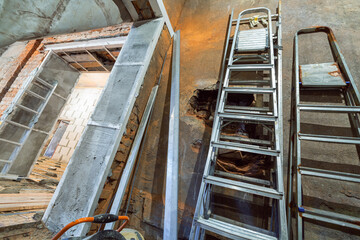 Wall Mural - Interior of apartment during construction, remodeling, renovation, extension, restoration and reconstruction - ladder and construction materials in the room. Concept of home improvement or renovate