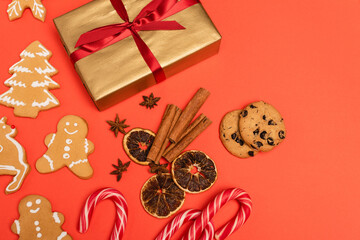 Canvas Print - top view of gift, candy canes, spices and gingerbread cookies on red 