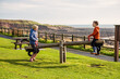 A young brother and sister playing on a seesaw in a park at Crail, Fife, Scotland. This park is on the coastal trail and is in a very beautiful location.