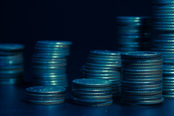 rows of coins and blurred bokeh for finance and banking concept