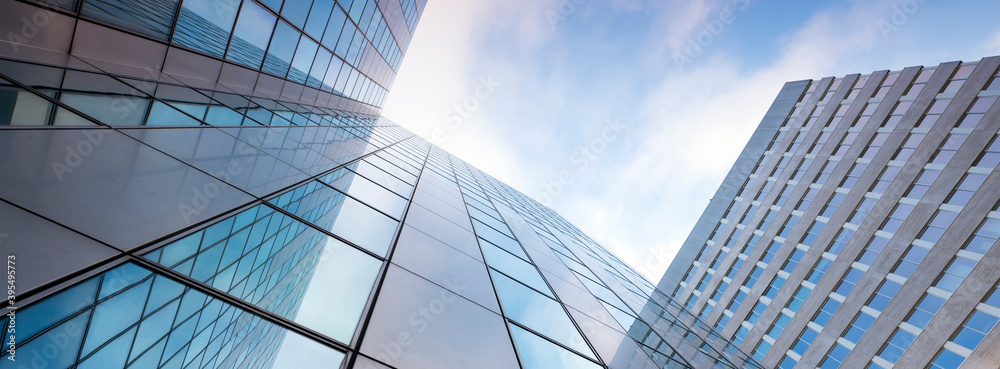 glass facades of modern office buildings and reflection of blue sky ...