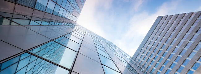 glass facades of modern office buildings and reflection of blue sky