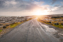 Small Narrow Asphalt Road To A Mountain. Burren Region, County Clare, Ireland. Low Cloudy Sky. Nobody,