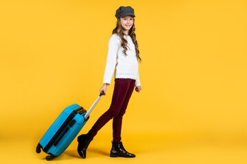 Poster - teen girl with suitcase for trip on yellow background, adventure